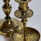 Duo of solid brass and gold metal candle holders worked old