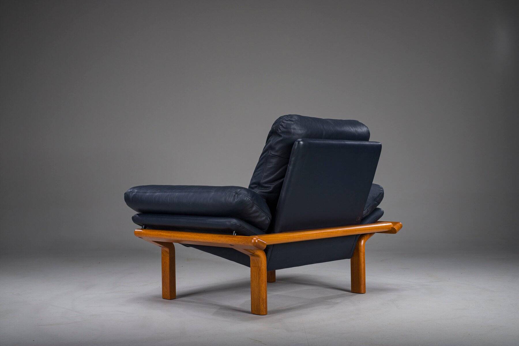 Danish teak and navy blue leather lounge chair from Komfort, 1970s