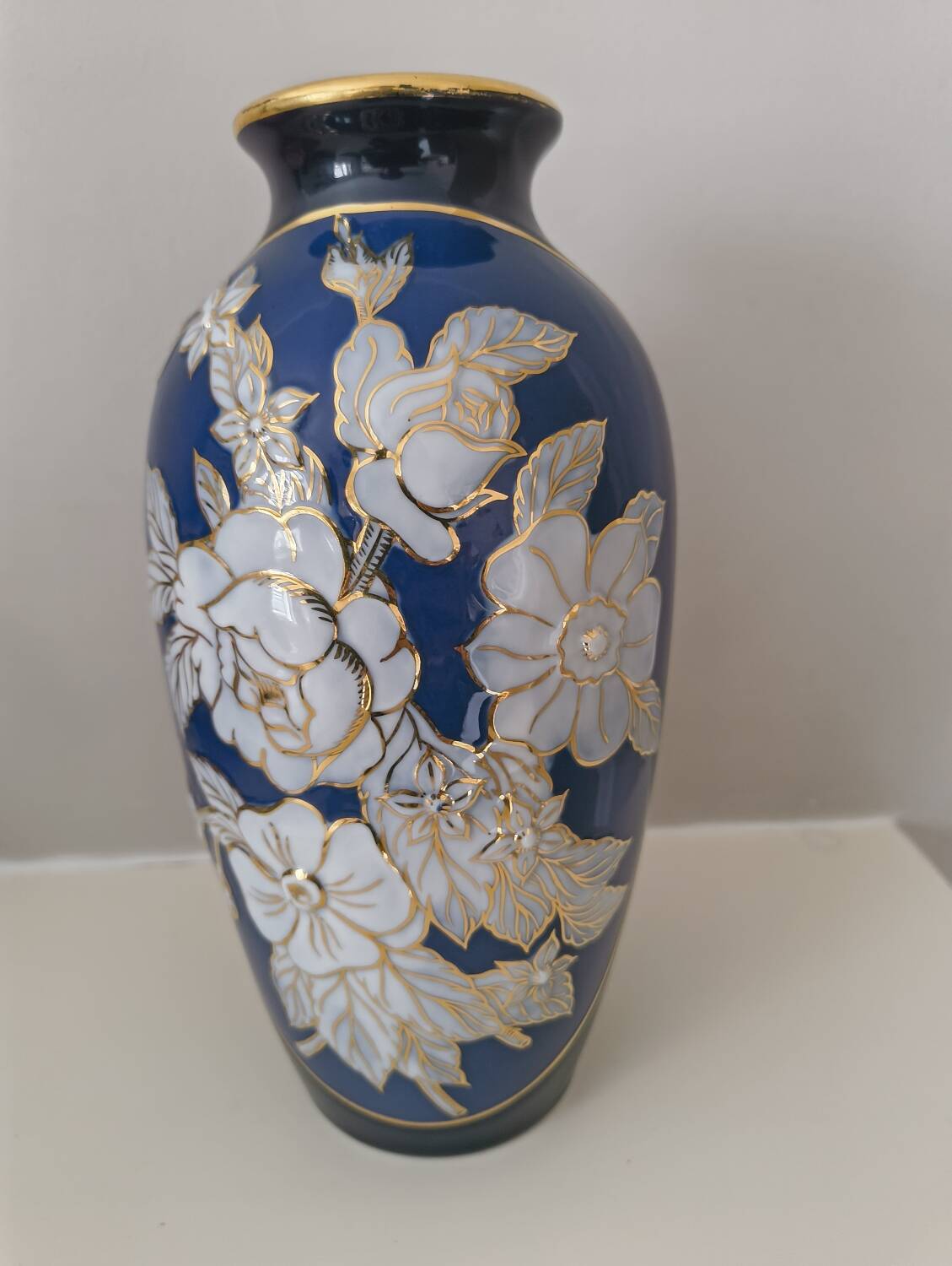 Cobalt blue porcelain vase from Limoges, France with floral pattern.