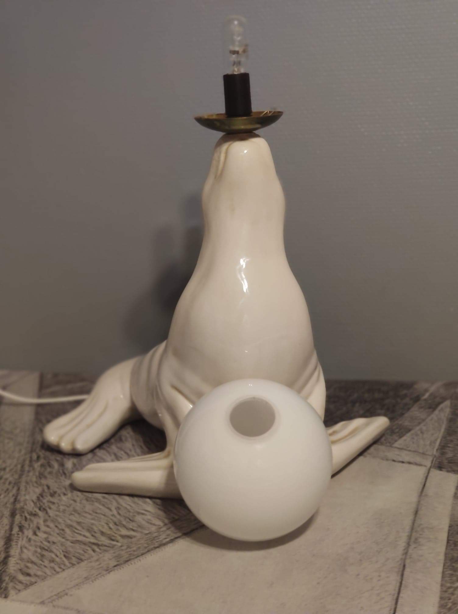 White ceramic sea lion lamp and opaline globe