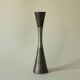 Set of three diabolo-shaped candle holders made of cast steel.