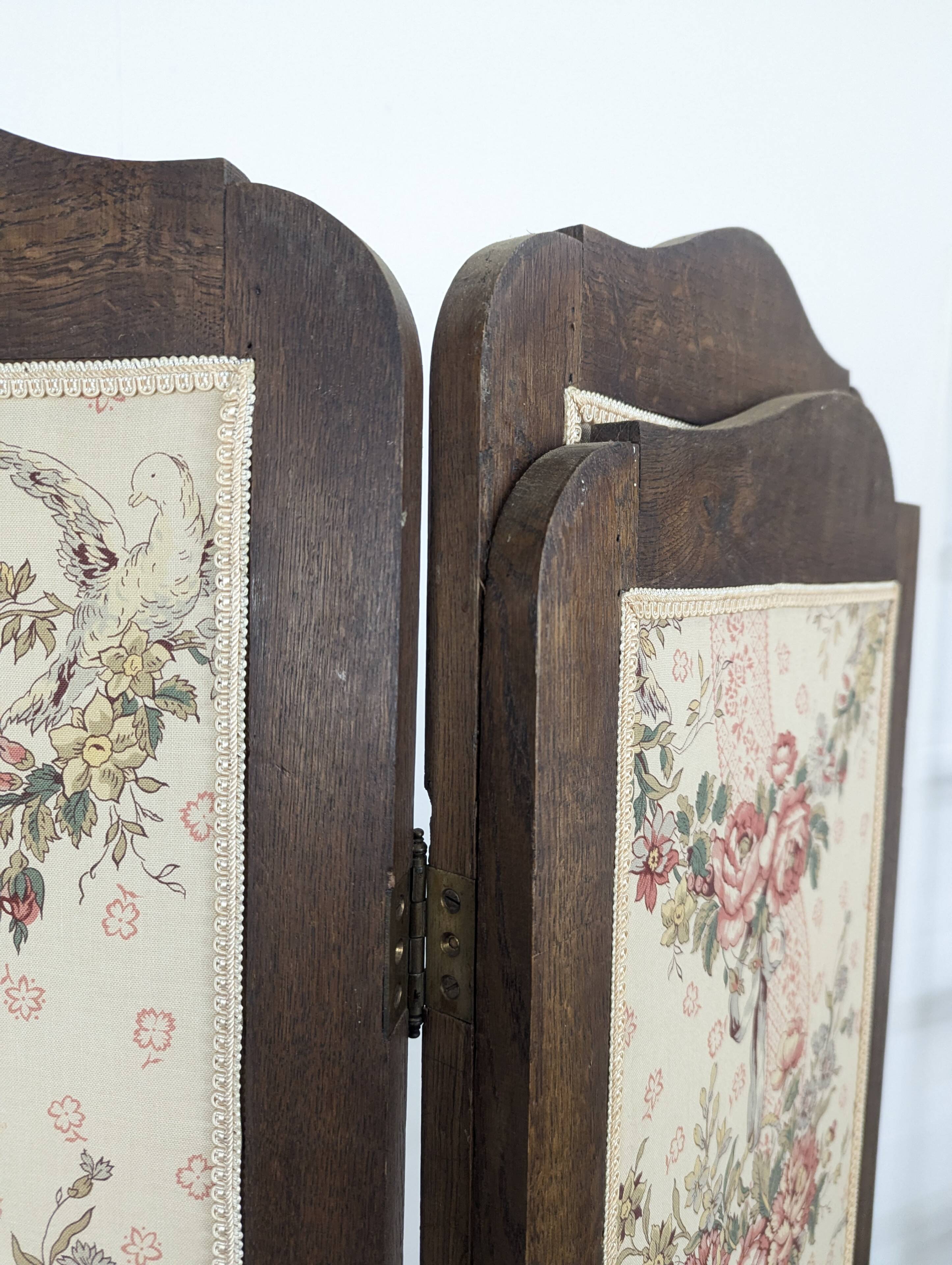 Four-panel oak screen adorned with floral upholstery from the 1930s.