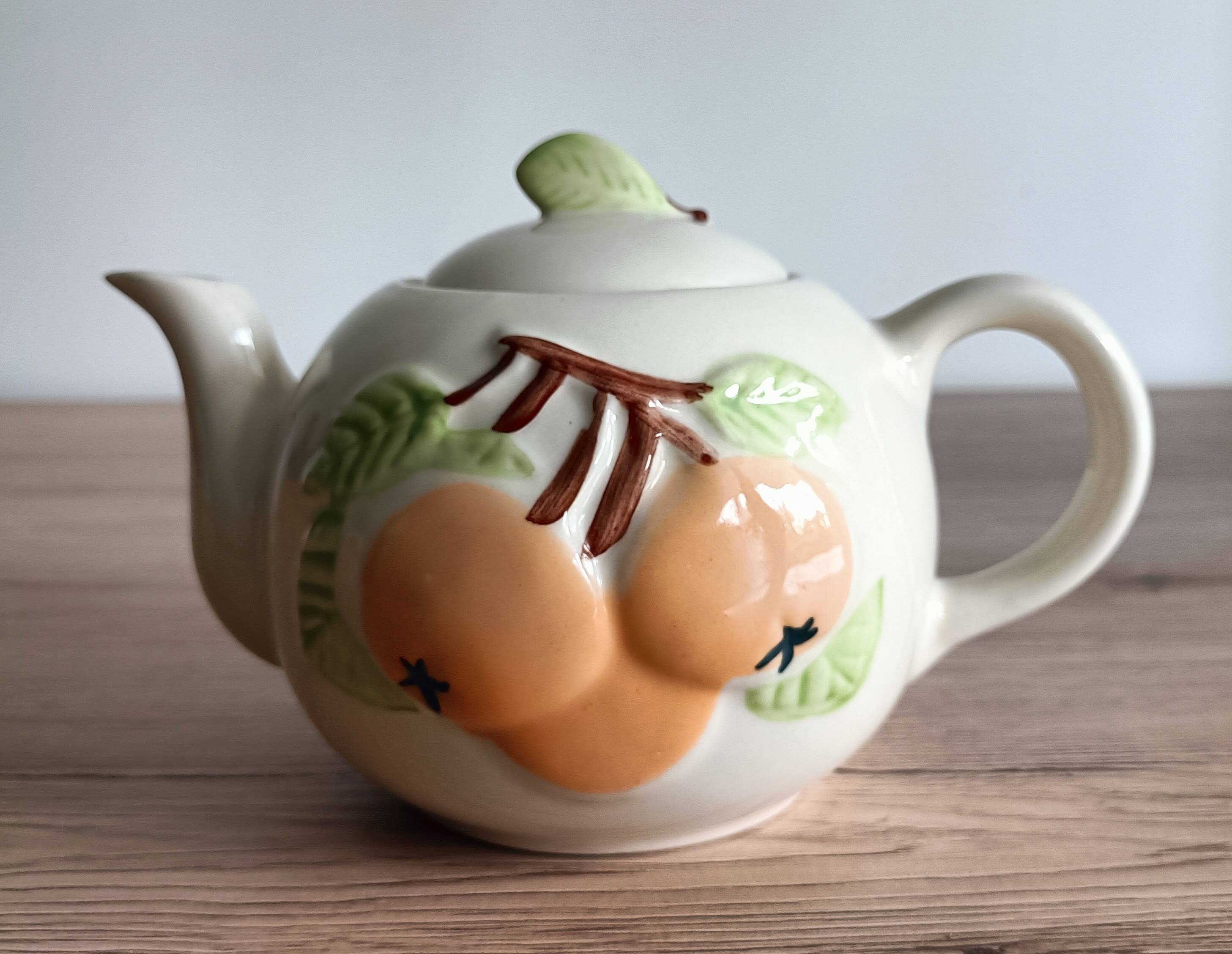 Slush teapot with embossed fruit decoration