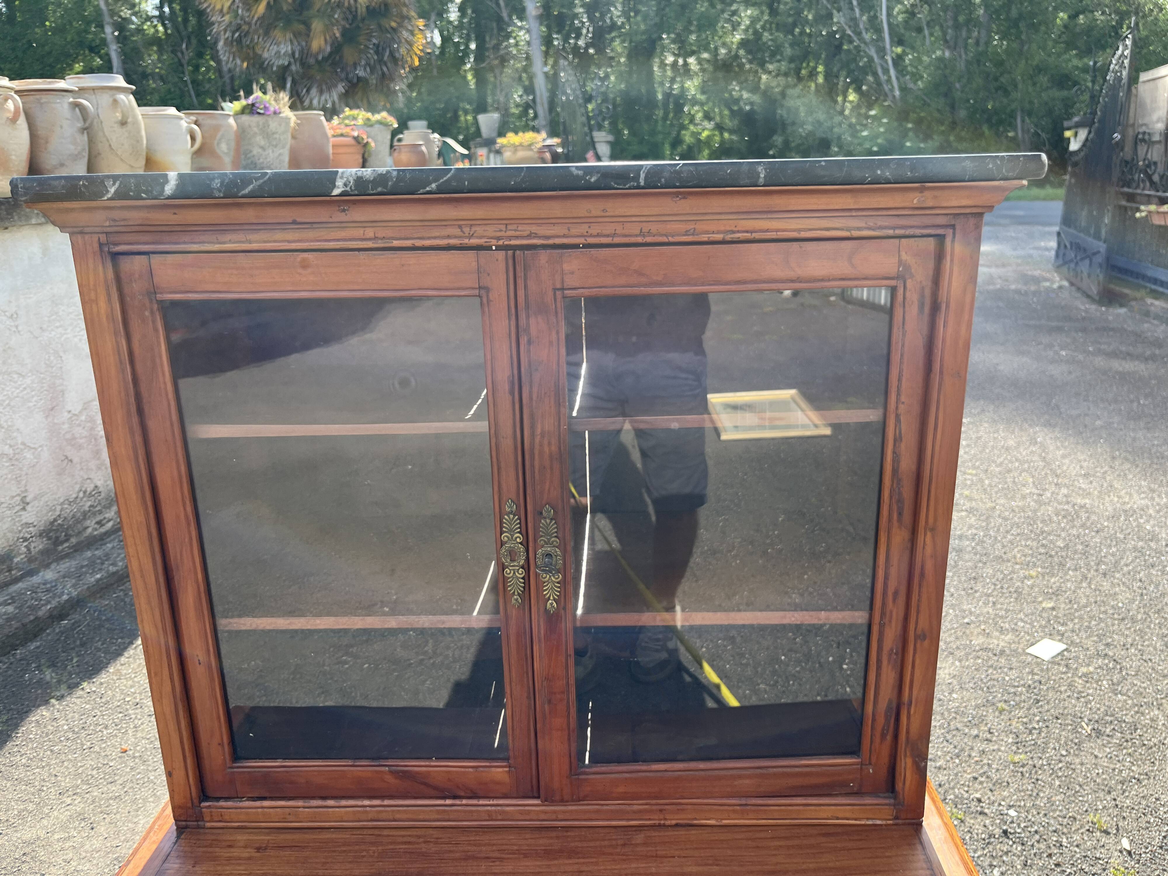 Victorian English two-body buffet with cherry wood on marble display case from the 19th century.