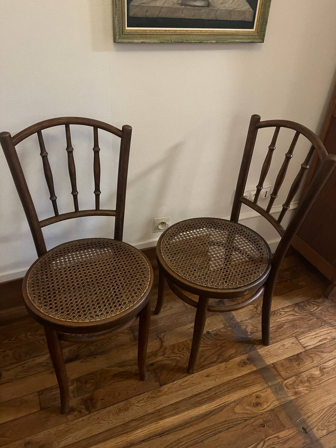 Pair of antique caned bistro chairs stamped Fischel