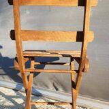 Foldable children's chair with beveled wooden slats