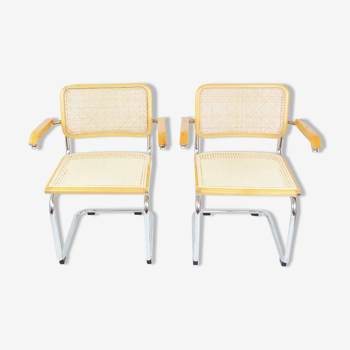 A pair of chairs with armrests, 1970s