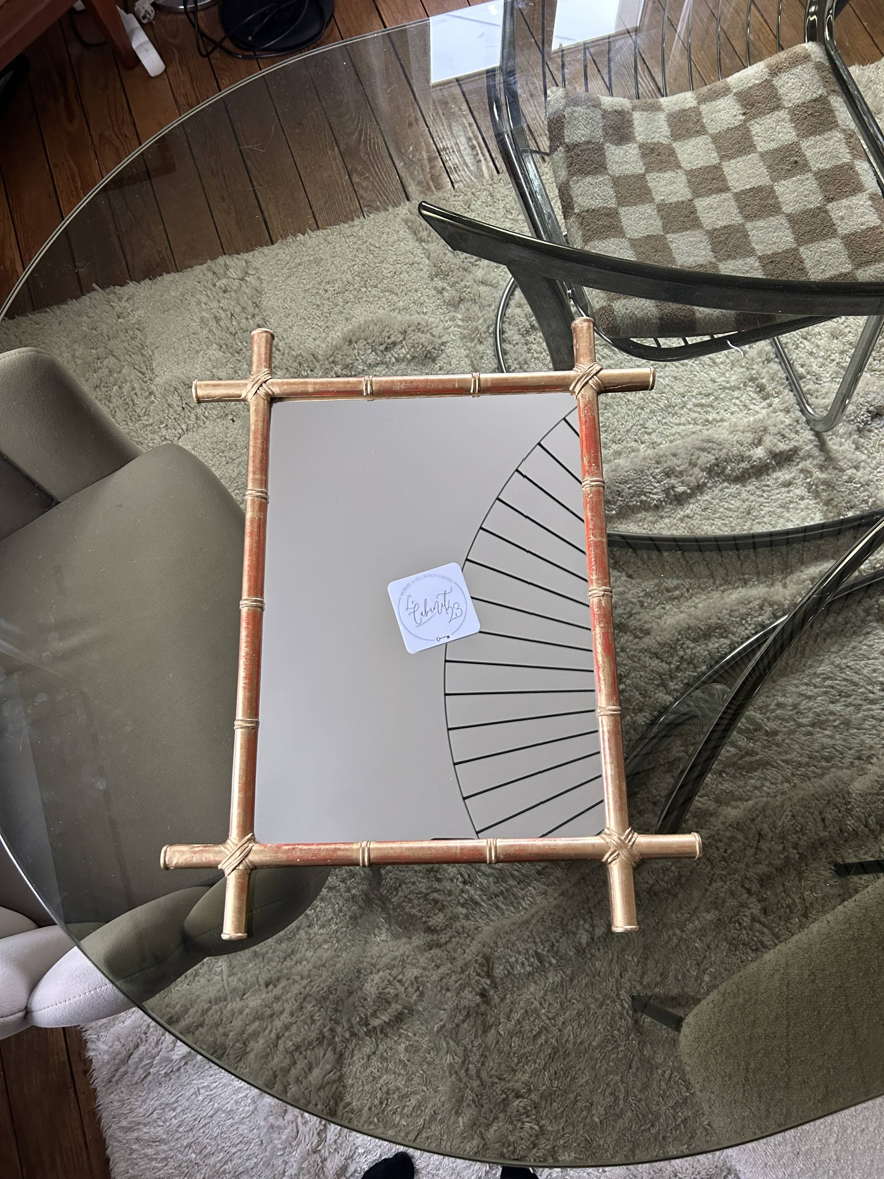 Mirror in gilded stucco, bamboo patina and gold leaf.