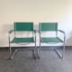 Pair of faux leather and chrome armchairs