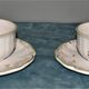 Two MOUSTIER cups decorated with flowers signed