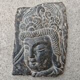 Antique portrait of Buddha hand-carved in stone, 19th century.