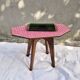 Small Scandinavian side table with wood and pink tiles, with tapered legs.