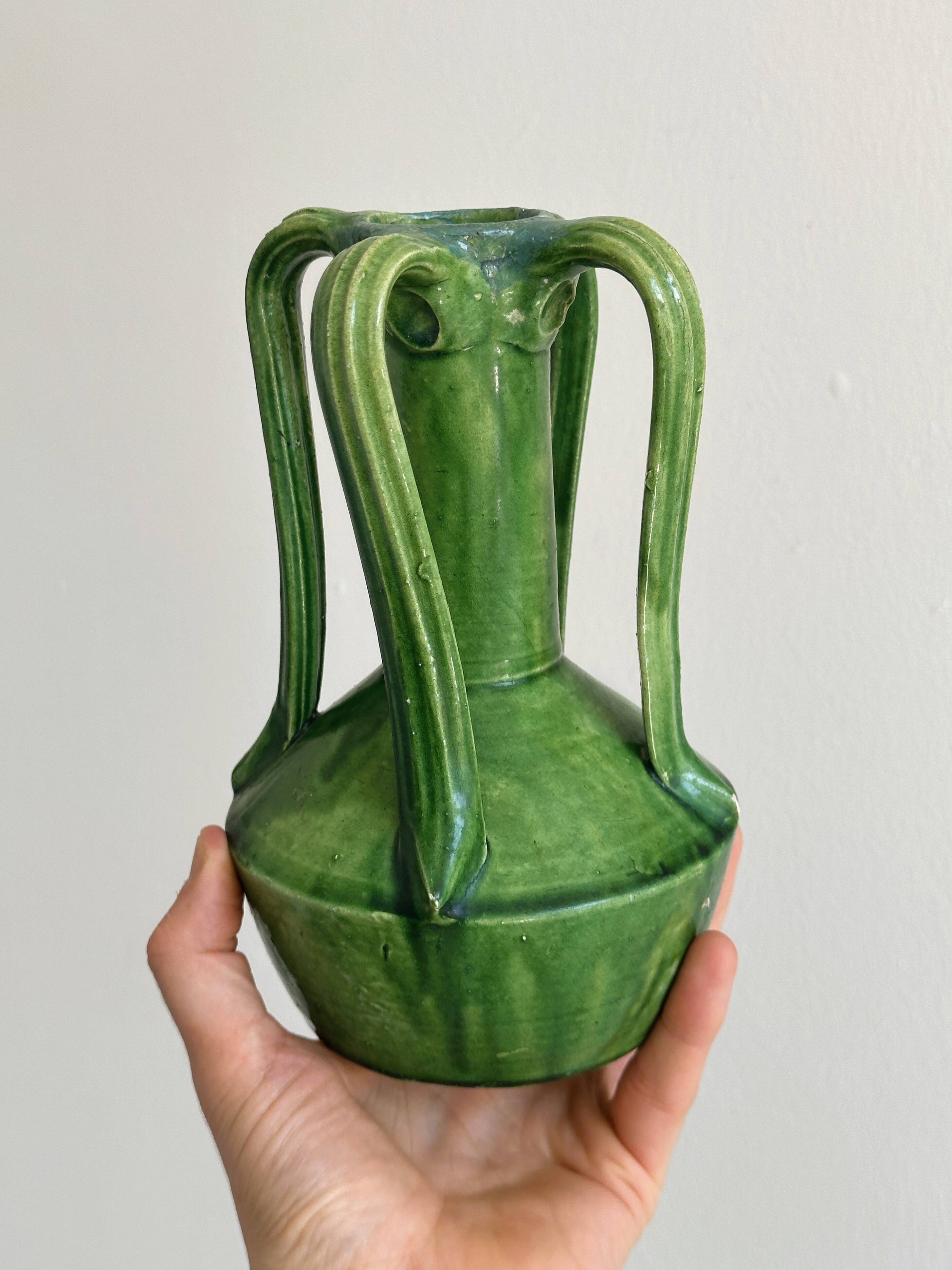 Pottery green ceramic vase with four handles.