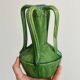 Pottery green ceramic vase with four handles.