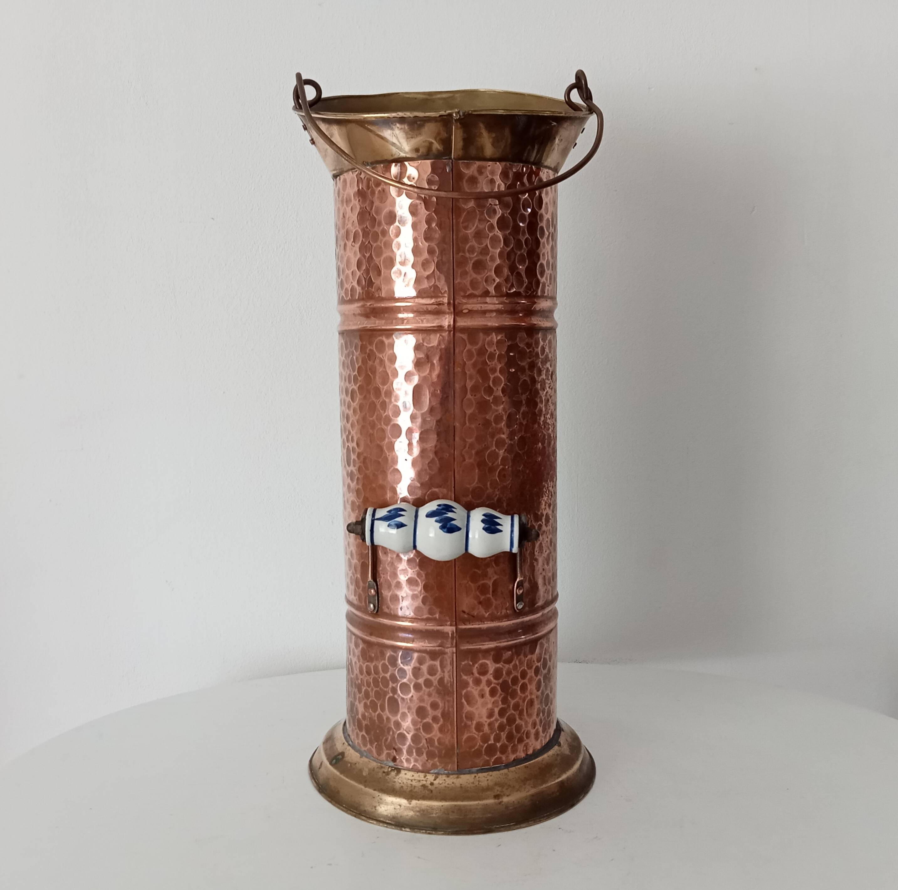 Old umbrella stand in copper, brass and porcelain