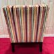Art Deco armchair in multicolored striped fabric and its footrest