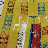 Mustard colored carpet with gazelle patterns berber style