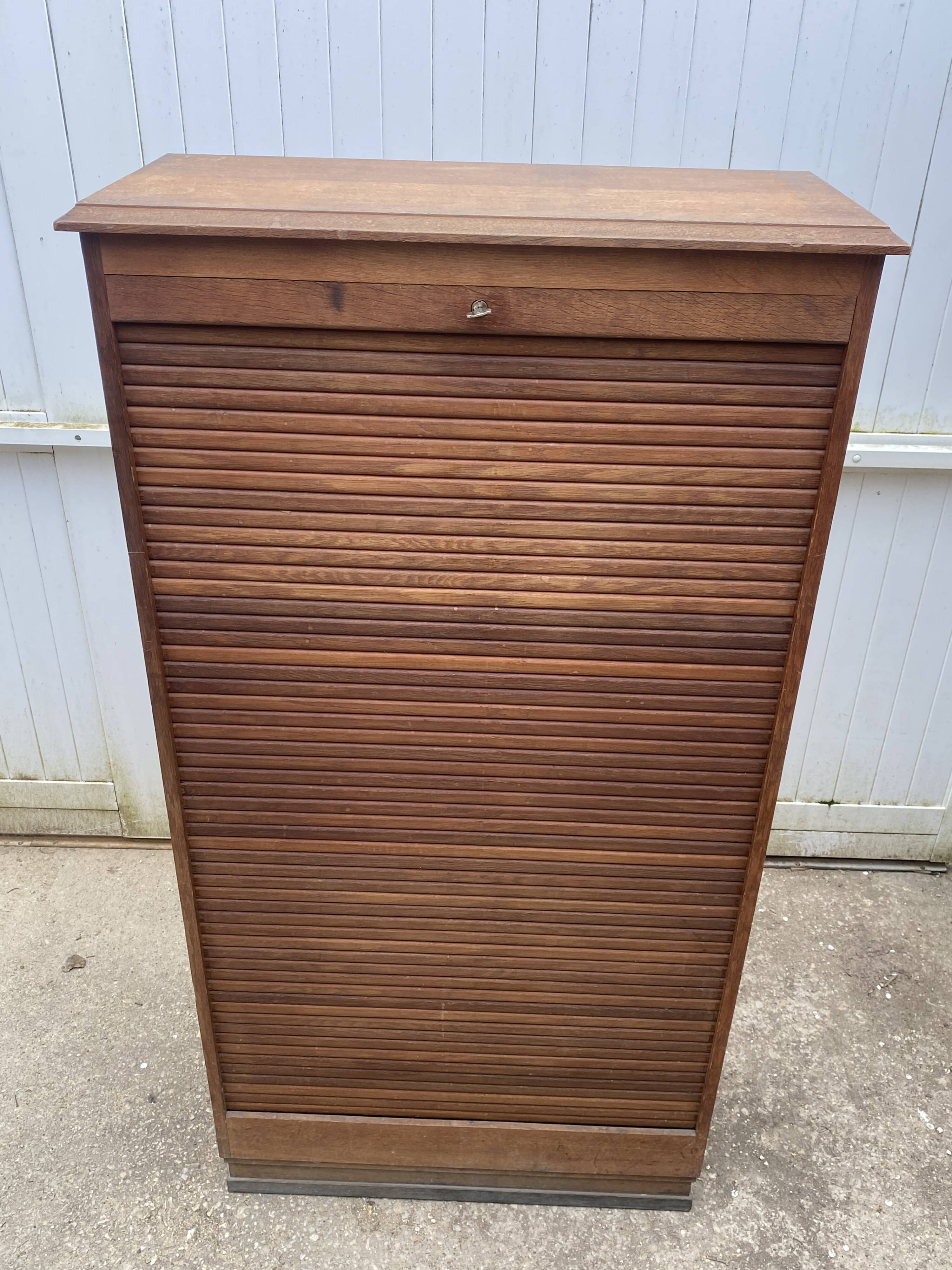 Oak two-column filing cabinet with curtains.