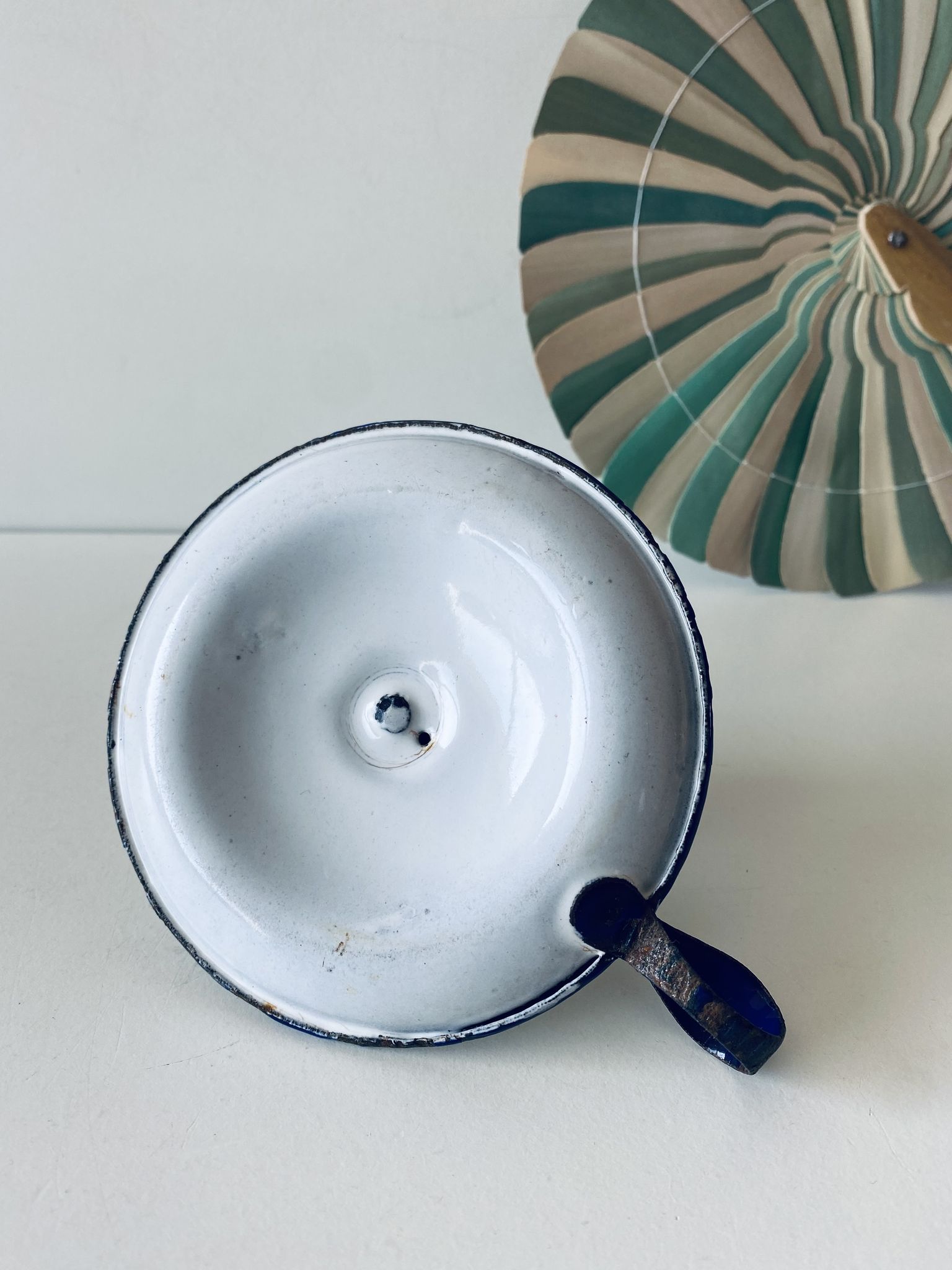 Antique candle holder in white and blue enamelled metal