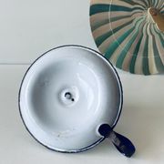 Antique candle holder in white and blue enamelled metal