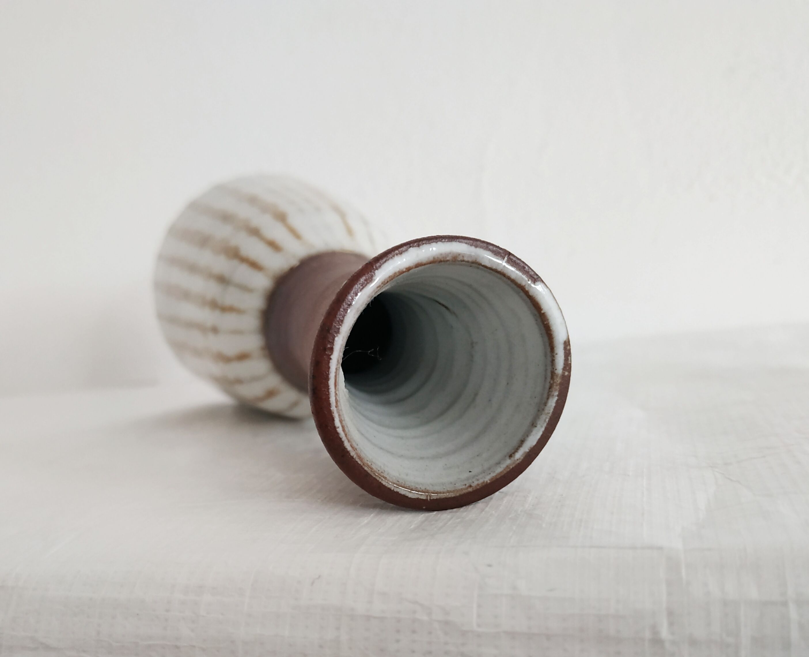 Small brown vintage vase with white enamels