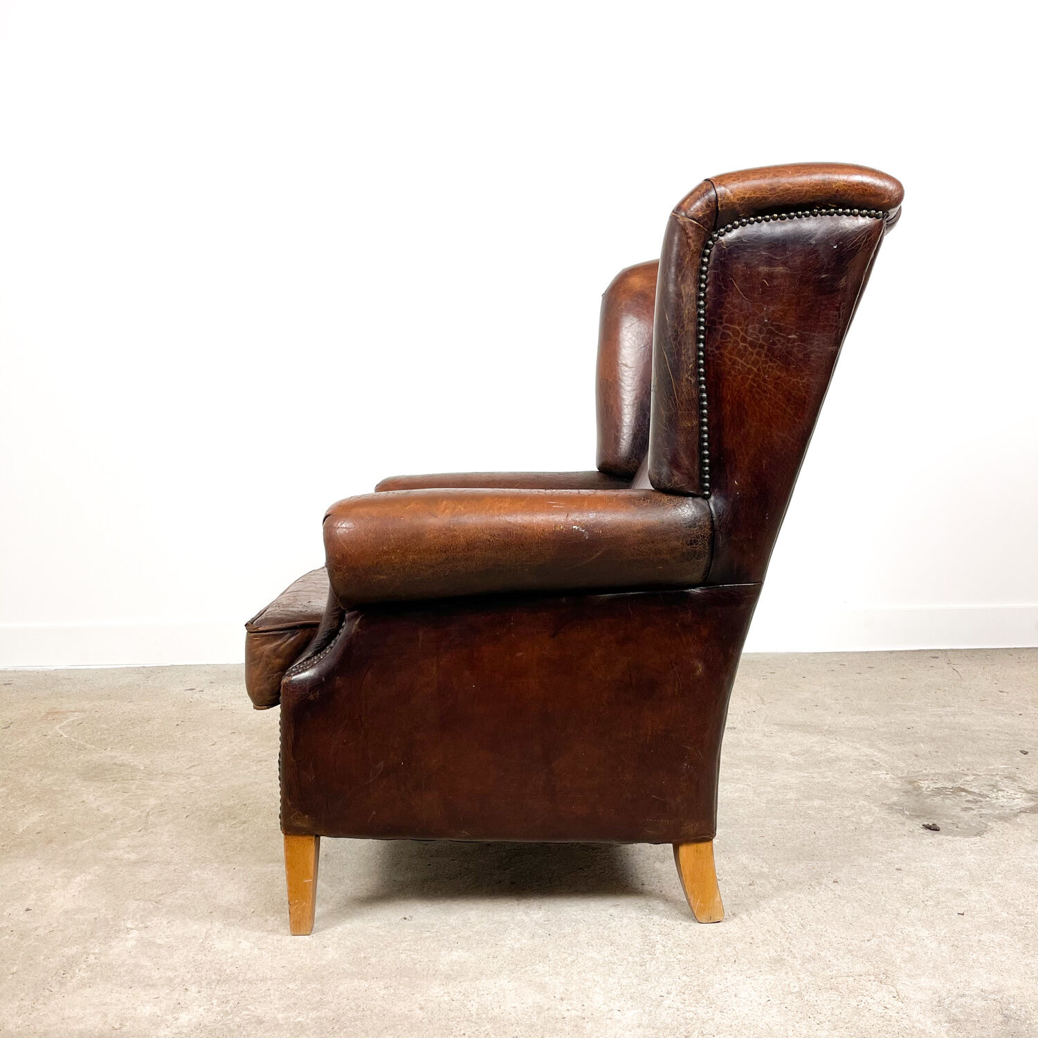 Dark brown vintage sheep leather wingback armchair