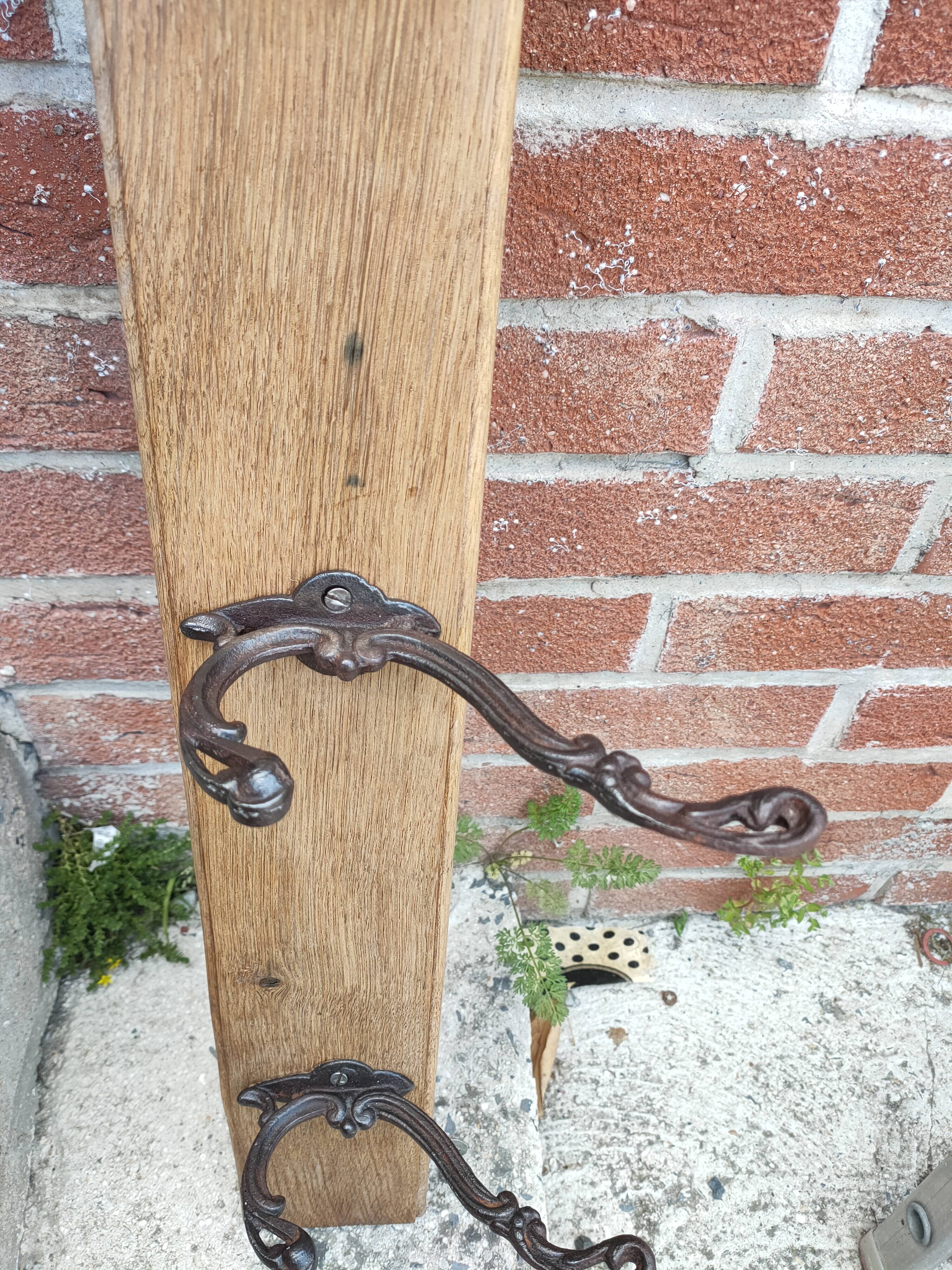 antique coat rack with 3 cast iron hooks