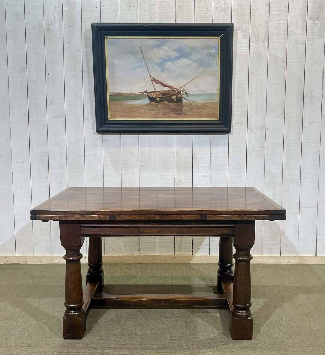 English monastery table with extensions from the late 19th century in elm and oak.