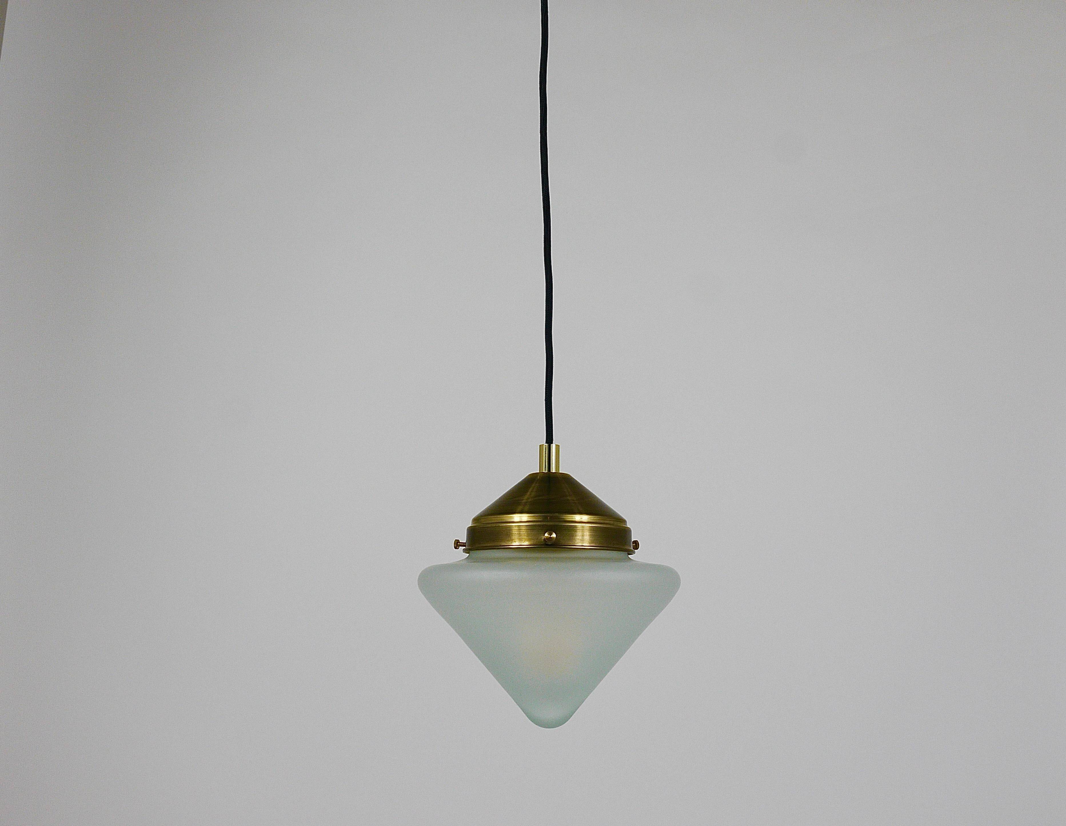 Up to 7 Art Deco brass pendant lights with conical glass shades, Vienna 1930s.