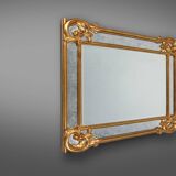 Richly decorated wall mirror in resin with golden ornaments and smoked mirror glass panels, Belgium,