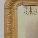 Louis Philippe mirror in wood and patinated stucco, 19th century.