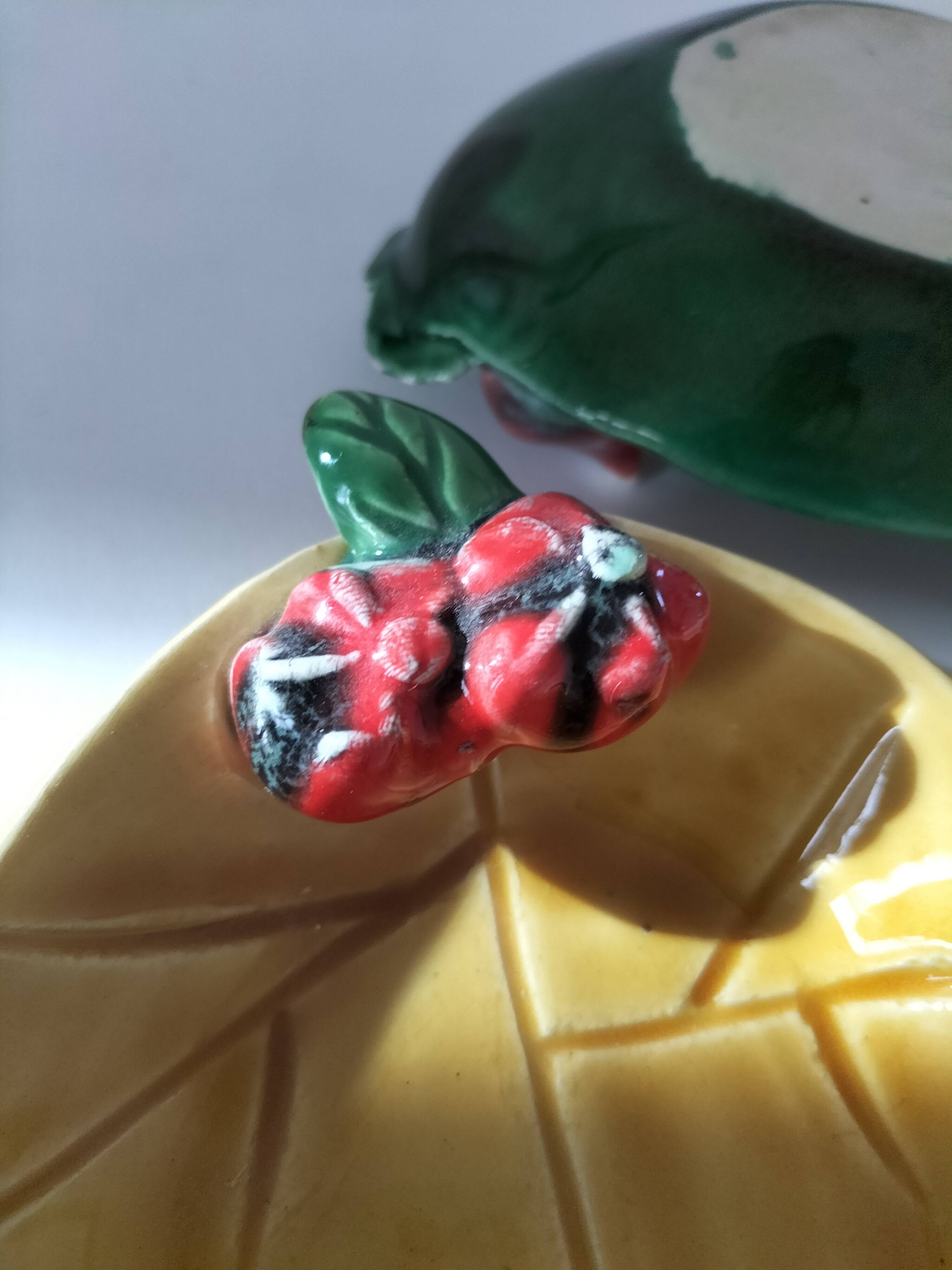 Two relief bowls with leaf designs, radishes, and tomatoes.