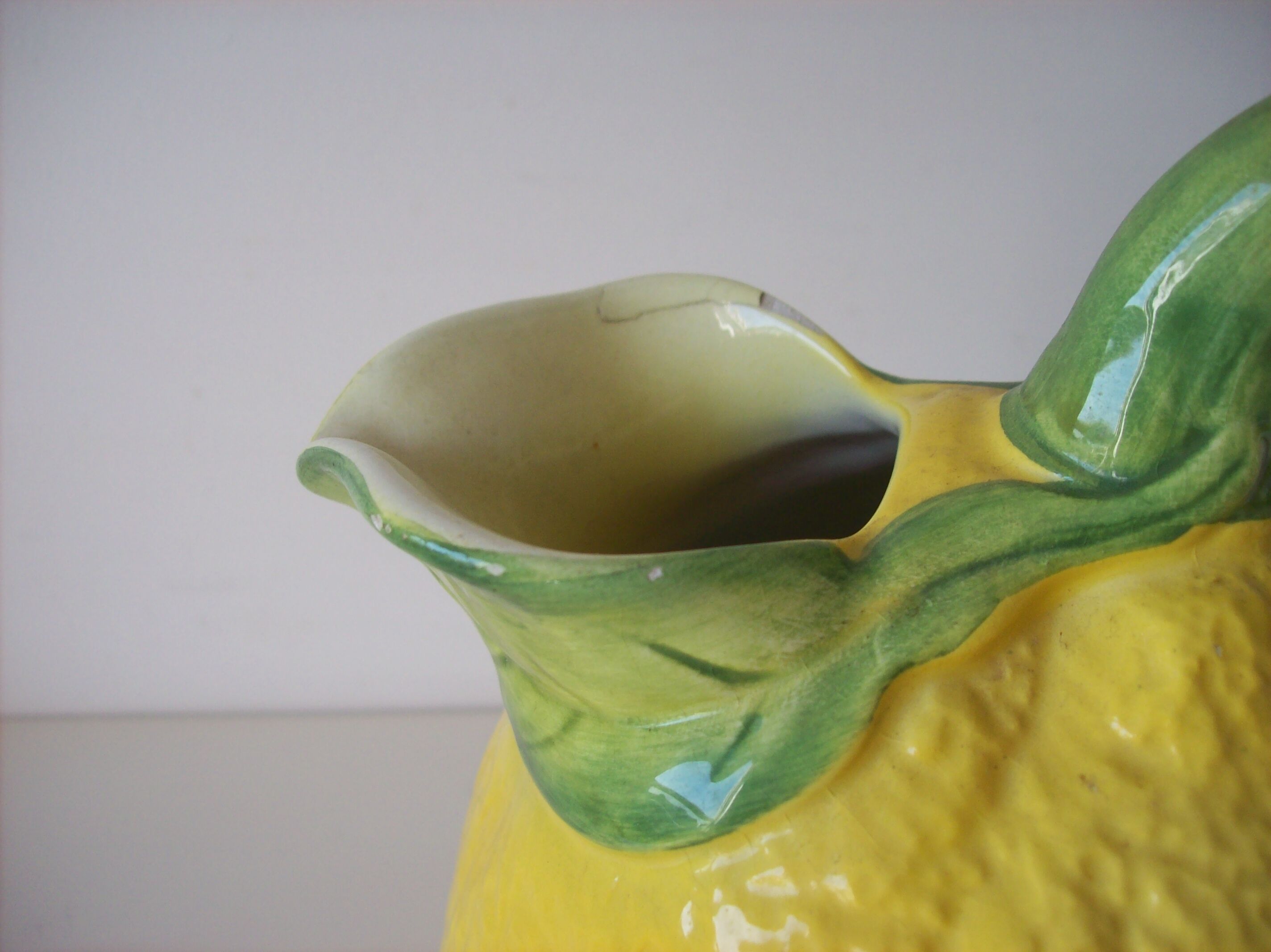 Vintage pitcher has form of lemon