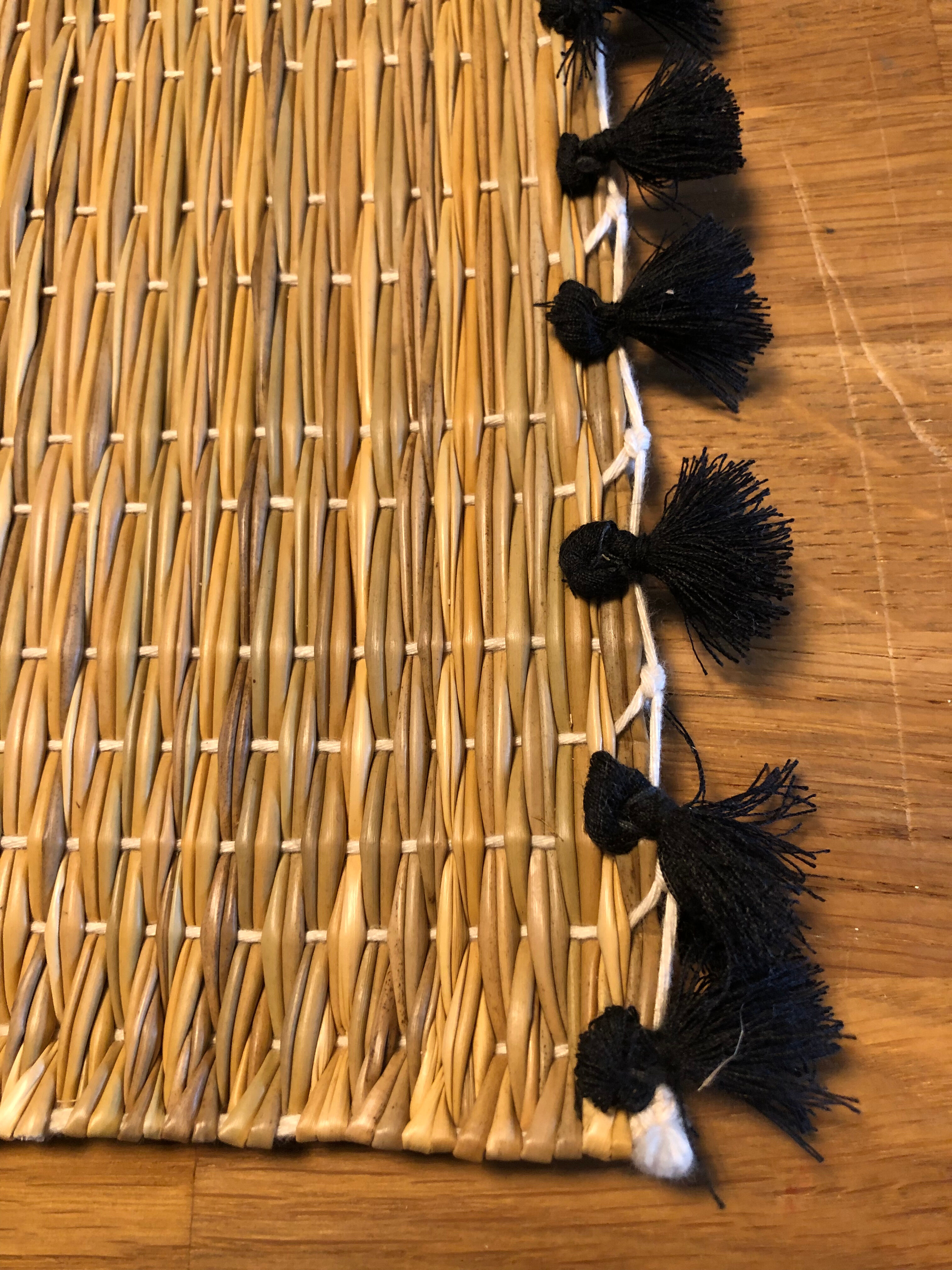 Braided placemats with pompoms