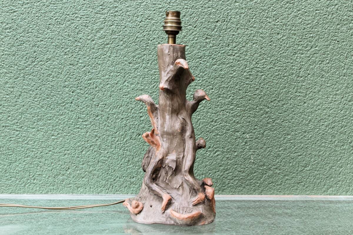 Lamp base in sculpted terracotta featuring birds, signed.