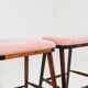 Bar stools matching the vintage style, in pink corduroy.