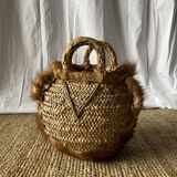 Handwoven vintage basket with handles made from natural fibres.