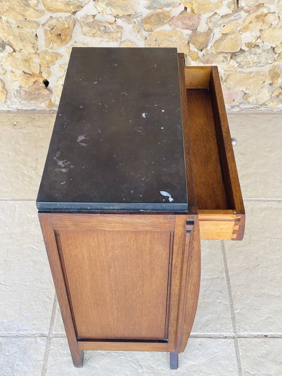 Art Deco bedside table in walnut, black marble top, circa 1920.