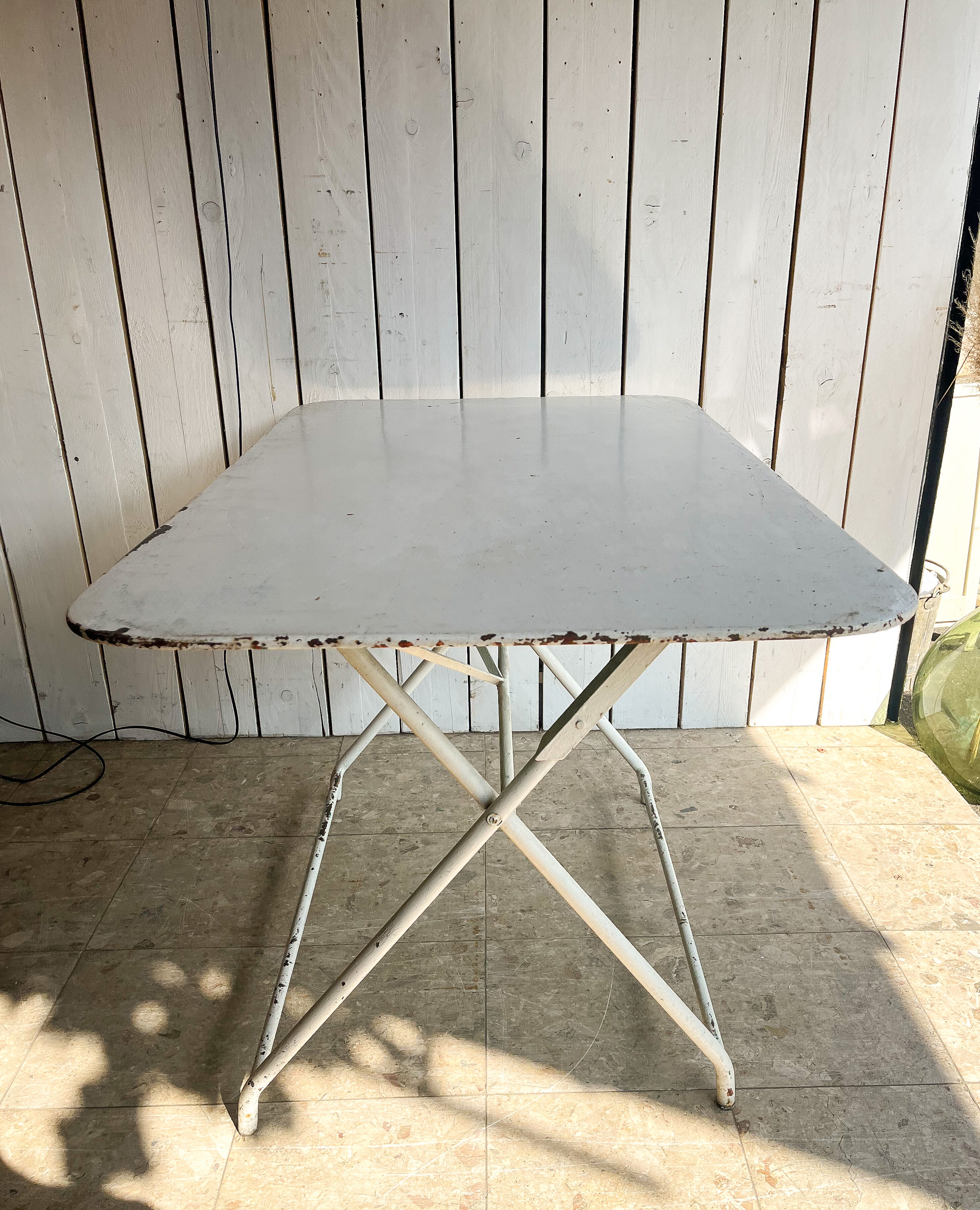 White folding metal bistro table