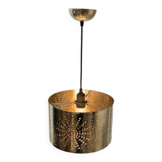 Hammered copper metal pendant light with a golden cylindrical shade.