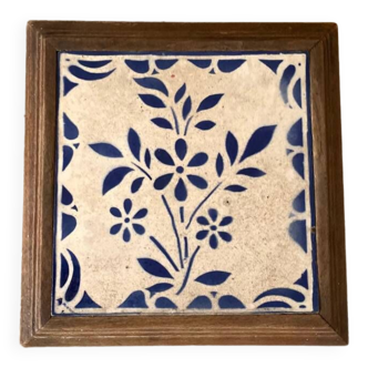Old trivet in wood and earthenware tiles