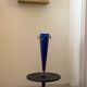 Cobalt blue vase on a metal structure.