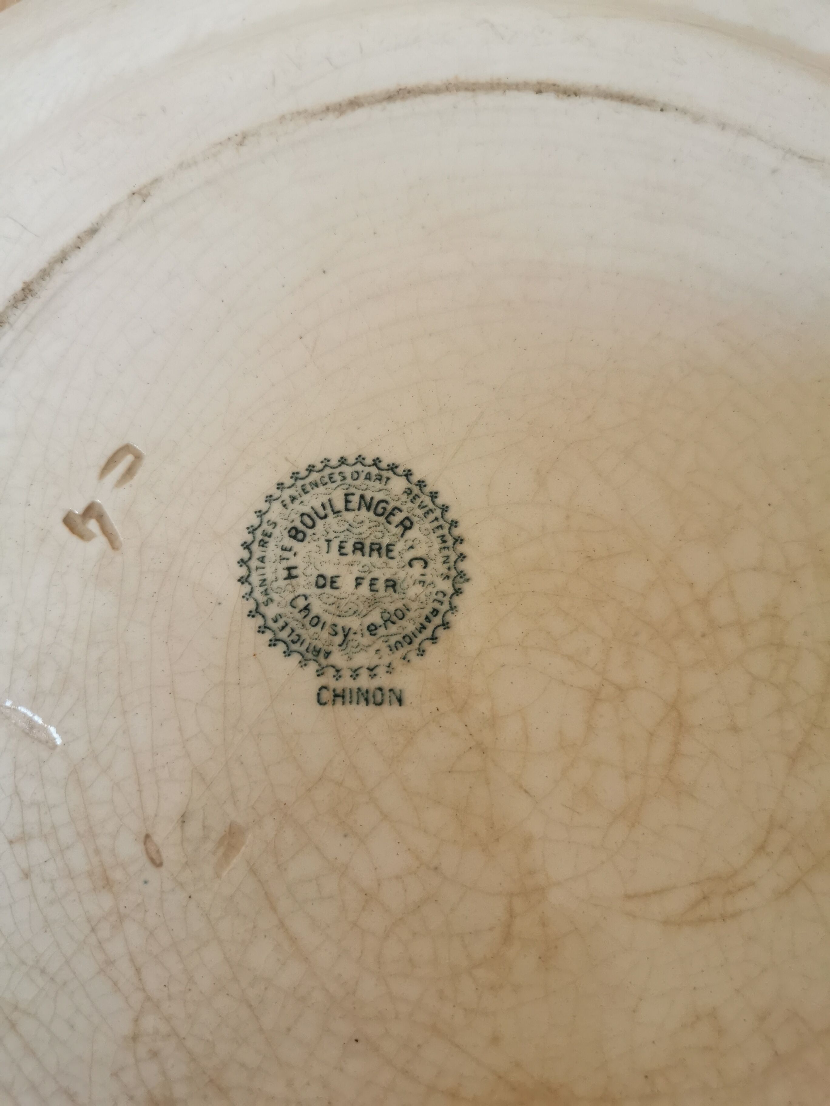 Large old round plate in iron earth