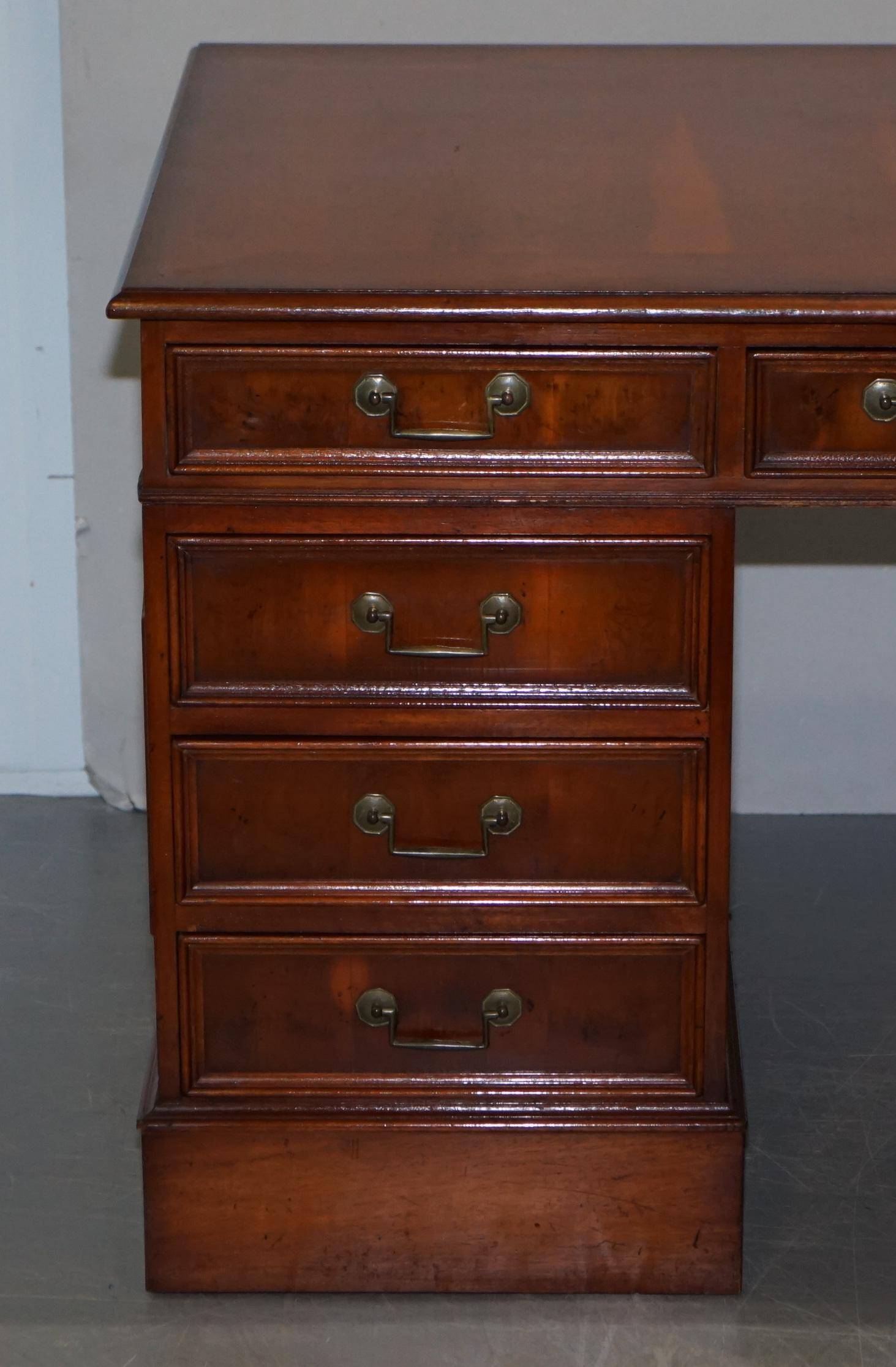 Partner desk with double pedestal in burr yew wood with decorated top.