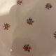 Dessert plate and porcelain dishes with a multicoloured floral pattern, vintage.