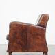 Dark brown design armchair made of sheepskin leather