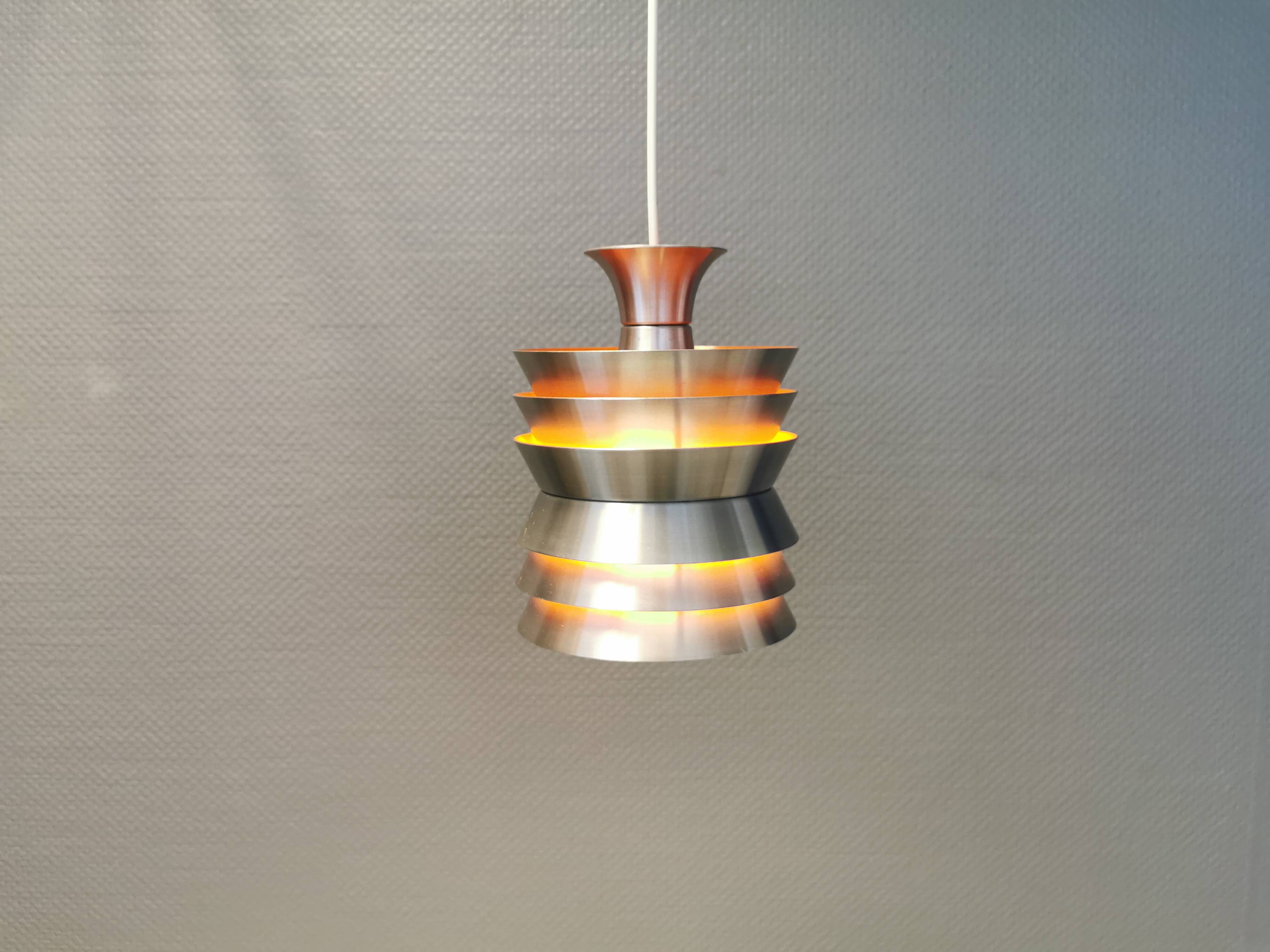 Danish/Swedish hanging lamp, in silver-coloured aluminium with orange interior paint.
