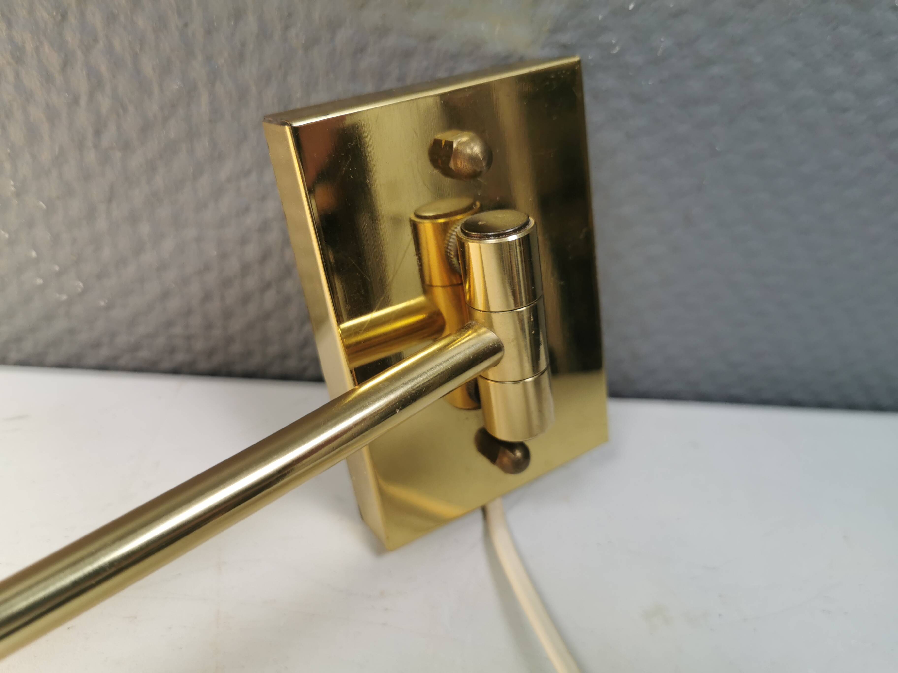 Danish Brass wall lamp with a ‘swivel’ effect.