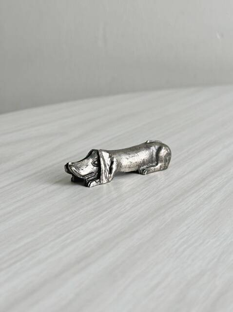 Antique metal knife rest in the shape of a dog.