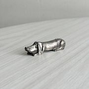 Antique metal knife rest in the shape of a dog.